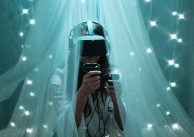 woman in white tank top holding black smartphone