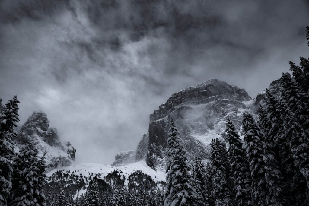 grayscale photography of summit view of mountain covered with snow